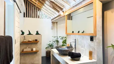 a bathroom with a sink and a mirror at Villa Sukacita - Family Friendly 4BR Seminyak Eat Street 900m Walk To Beach in Seminyak