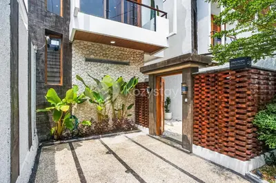 a entrance to a building with a brick wall at Calisee Villa by Kozystay - Denpasar in Seminyak