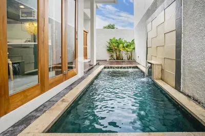 a swimming pool in the middle of a house at Calisee Villa by Kozystay - Denpasar in Seminyak