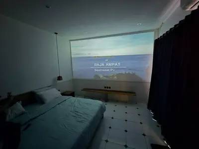 a bedroom with a bed and a large window at Villa crush of heart with swimming pool in Umalas