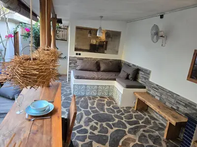 a living room with a couch and a table at Villa crush of heart with swimming pool in Umalas