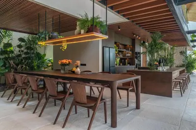 a dining room with a large wooden table and chairs at Villa Baratega - Dreamy Urban Tropical 6BR Villa for Large Group in Kerobokan