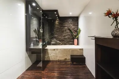 a bathroom with a shower and a bath tub at Timang Villa, Jimbaran-Bali in Jimbaran