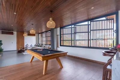 a living room with a pool table in it at Oza Villa Canggu Managed by LEAD in Canggu