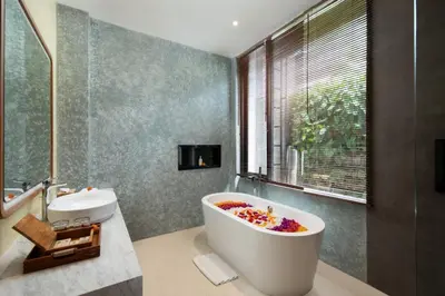 a bathroom with a large bath tub with a sink at Oza Villa Canggu Managed by LEAD in Canggu