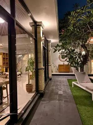 a house with a room with plants in it at Tranquil Family Villa Retreat in Umalas in Kerobokan