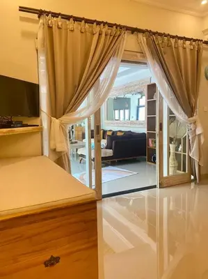 a bedroom with a bed and a living room at Tranquil Family Villa Retreat in Umalas in Kerobokan