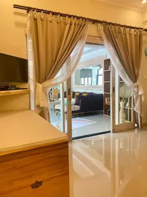 a bedroom with a bed and a living room at Tranquil Family Villa Retreat in Umalas in Kerobokan