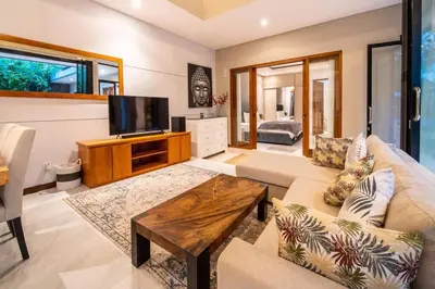 a living room with a couch and a tv at Cozy villa in Umalas in Kerobokan