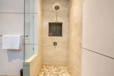 a bathroom with a shower with a glass door at Cozy villa in Umalas in Kerobokan
