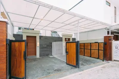 an open garage with wooden doors in a building at The Lavana Sahadewa Villa Kuta Sunset in Legian