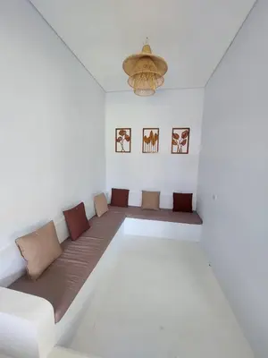 a room with a couch in the middle of a room at Double D Guesthouse and Villa in Kerobokan