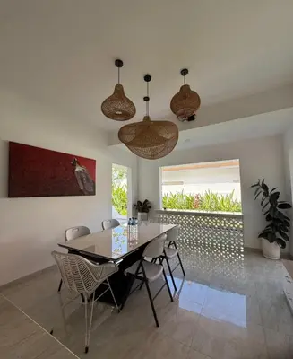 a dining room with a table and chairs at New 2BR Villa Private Pool Near Seminyak in Kerobokan