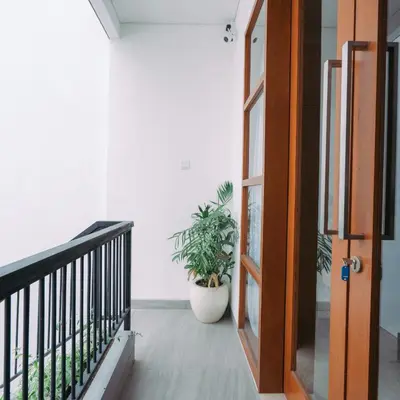 a door leading to a balcony with a plant at The Lavana Nakula Villa Kuta Sunset in Kuta