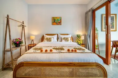 a bedroom with a large bed with oranges on it at Arts Tamansari Villa Two-Bedroom Private Pool Kuta in Kerobokan