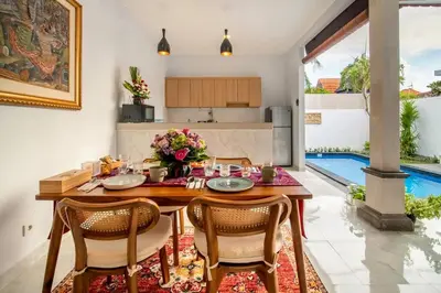 a kitchen and dining room with a table and chairs at Arts Tamansari Villa Two-Bedroom Private Pool Kuta in Kerobokan