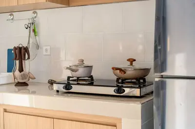 a kitchen with two pots and pans on a stove at Arts Tamansari Villa Two-Bedroom Private Pool Kuta in Kerobokan