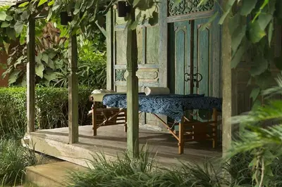 an outside area of a house with a chair and a window at Villa Mamoune in Canggu