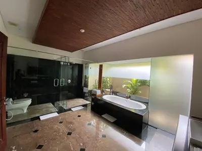 a large bathroom with a tub and a sink at Bintang Bali Villa in Kuta