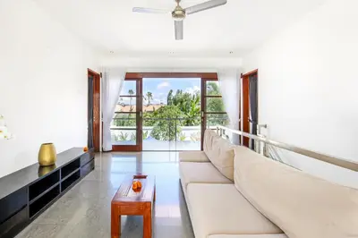 a living room with a couch and a table at Villa Lilja in Seminyak