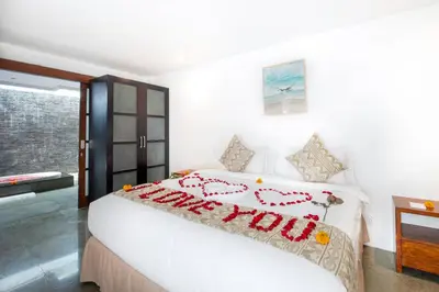 a bedroom with a bed with a happy new year sign on it at Villa Lilja in Seminyak
