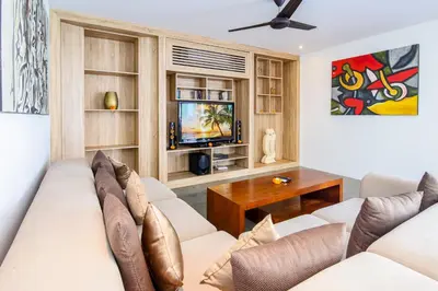 a living room with a couch and a tv at Villa Lilja in Seminyak