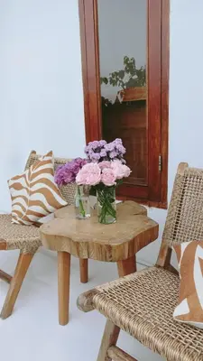 a table with a vase of flowers on it at Vee Surf in Canggu