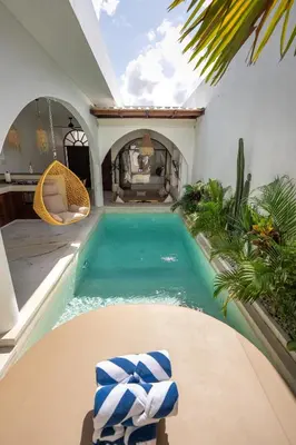 a swimming pool in the middle of a house at Sueño Villa Seminyak in Seminyak
