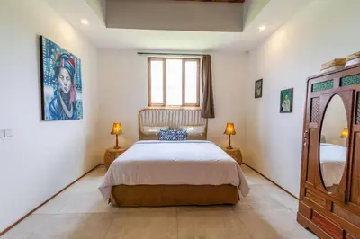 a bedroom with a bed and two lamps and a window at Villa Jannu by DreamAwayBali in Seminyak