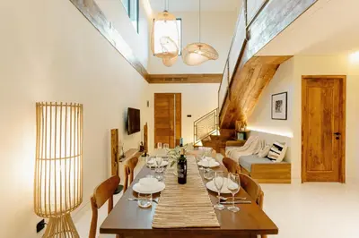 a dining room with a long table and chairs at Balimac Villa 3 in Seminyak