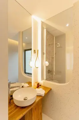 a bathroom with a white sink and a mirror at Balimac Villa 3 in Seminyak