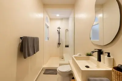 a bathroom with a sink and a toilet and a mirror at Wayang Villa by Betterplace in Kerobokan