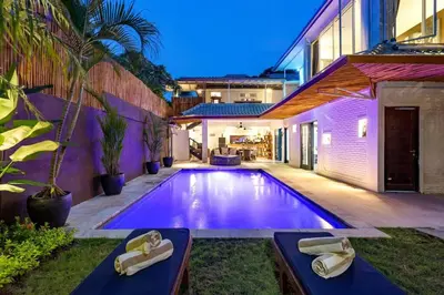 a swimming pool in the backyard of a house at Villa Julietta, 4 BR in the heart of Seminyak in Seminyak