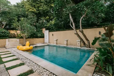 a swimming pool with a rubber duck in a yard at Villa Anggrek Jimbaran in Jimbaran