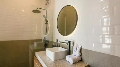 a bathroom with a sink and a mirror at Sunset D1 Villa by Betterplace in Kerobokan