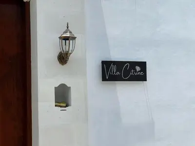 a sign on a wall with a light and a lamp at LUX 3 Bedroom Villa 5min Walk to the Beach in Canggu
