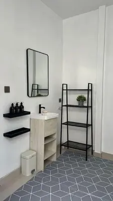 a bathroom with a sink and a mirror and a shelf at LUX 3 Bedroom Villa 5min Walk to the Beach in Canggu