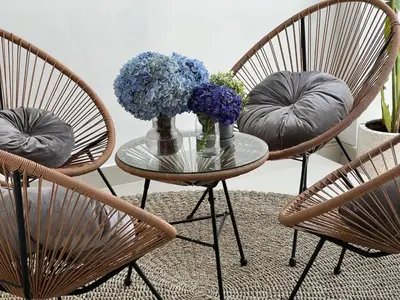 three chairs and a glass table with flowers on it at Nomadic LUX villa in Canggu