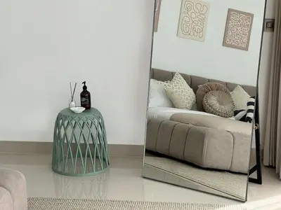 a mirror in a living room with a couch and a table at Nomadic LUX villa in Canggu