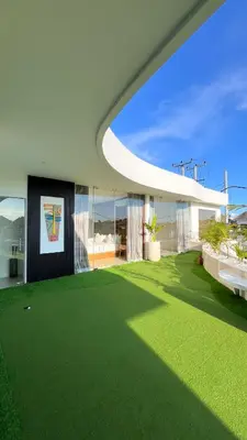 an exterior view of a house with green grass at Villa Soluna Luxury 4BD Villa with Pool & Zen Vibes in Seminyak
