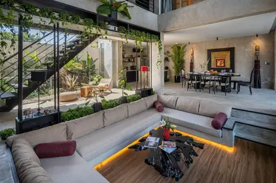 a living room with a large couch and a table at Artistic 4BD Villa with Private Pool & Jungle Vibes in Seminyak
