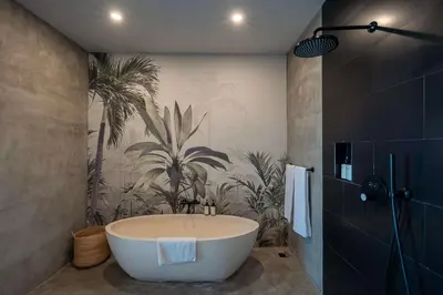 a bathroom with a bath tub and a palm mural at Artistic 4BD Villa with Private Pool & Jungle Vibes in Seminyak
