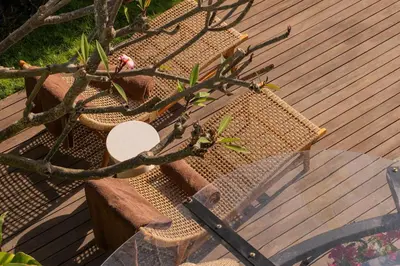 two wicker chairs sitting on top of a wooden deck at Luxury 4BD Villa Casa Diplomatico with Private Pool in Seminyak