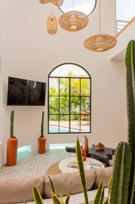 a living room with a large window and cactus at Luxury 4BD Villa Casa Diplomatico with Private Pool in Seminyak