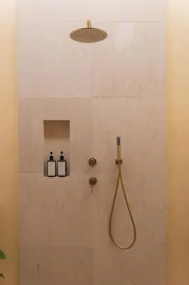 a bathroom with a shower with two bottles on the wall at Luxury 4BD Villa Casa Diplomatico with Private Pool in Seminyak