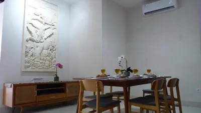 a dining room with a wooden table and chairs at Private Villa Fabian - Lap pool - Seminyak in Seminyak