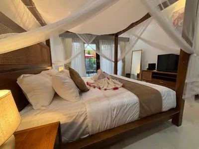 a bedroom with a bed with a canopy at Private Villa Fabian - Lap pool - Seminyak in Seminyak