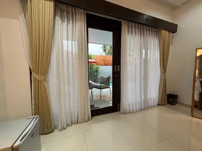 a living room with a sliding glass door to a patio at Private Villa Fabian - Lap pool - Seminyak in Seminyak