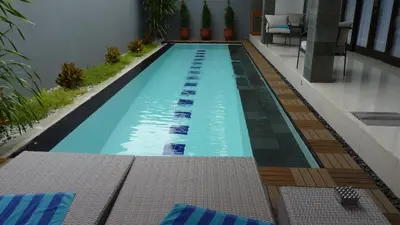 a swimming pool in the middle of a house at Private Villa Fabian - Lap pool - Seminyak in Seminyak