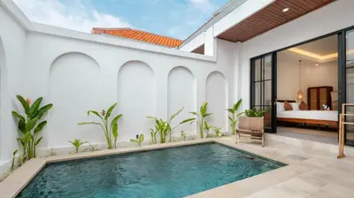an indoor pool in a villa with a bedroom at Kamila Villa 2 by Villa Finder in Seminyak